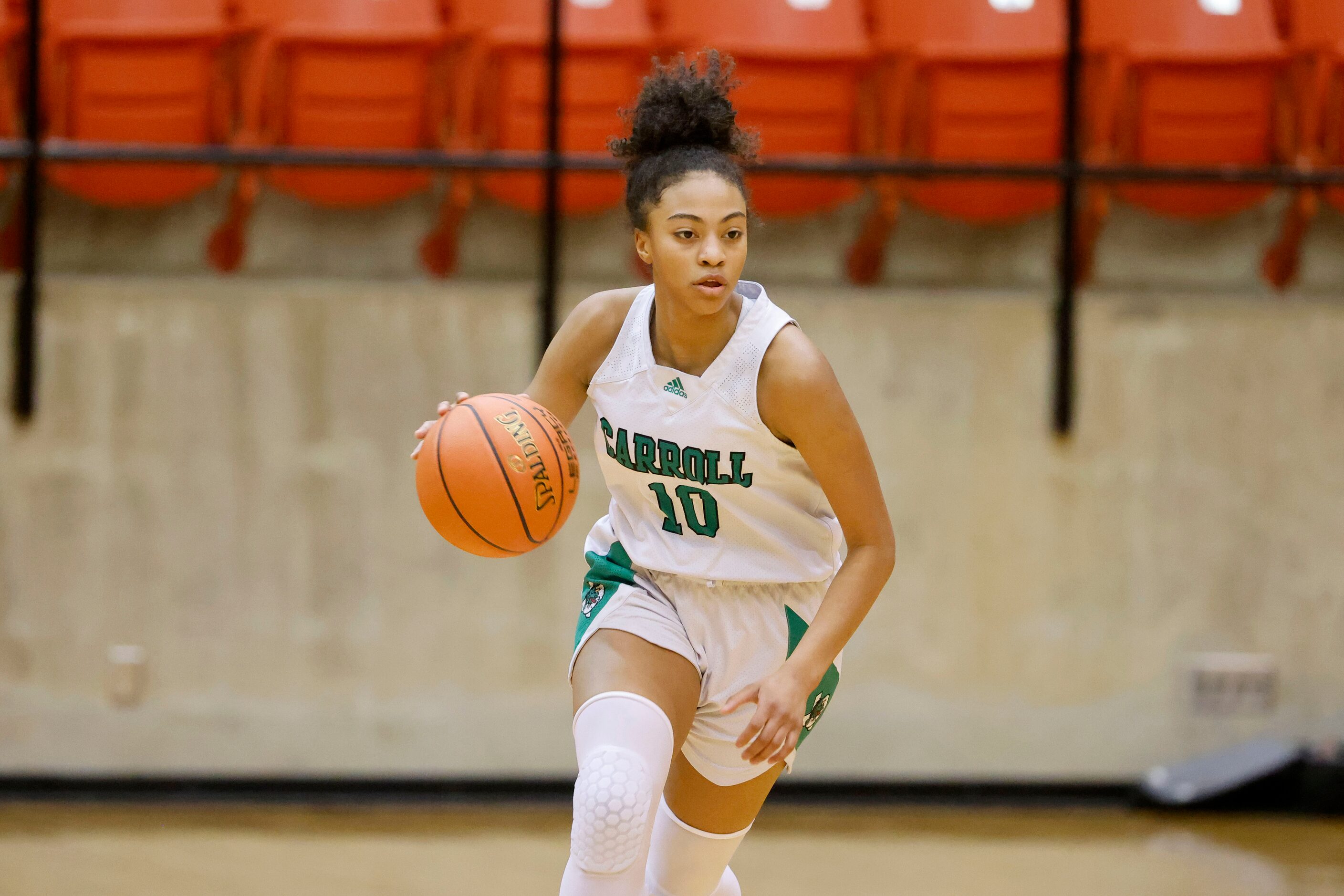 Southlake Carroll’s Milania Jordan (10) moves the ball up the court against South Grand...