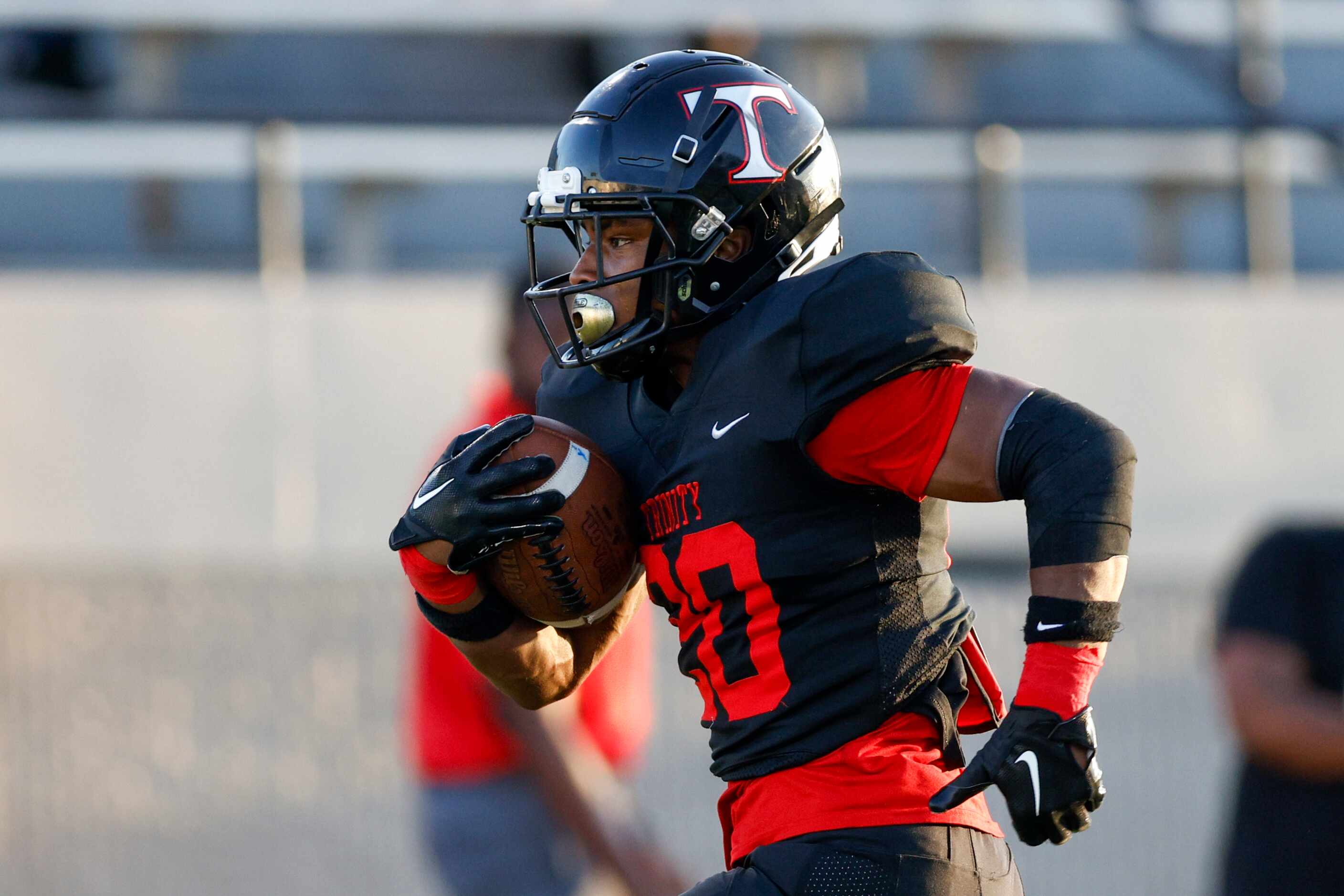 Euless Trinity running back Josh Bell (20) runs for a touchdown during the first half of a...