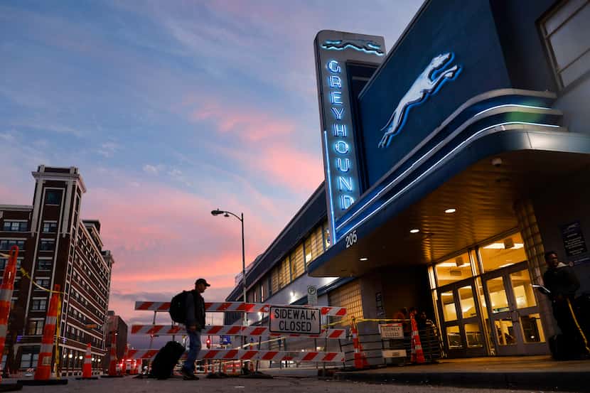 At sunset, a passenger arrives at the Greyhound bus station on S Lamar St in downtown...