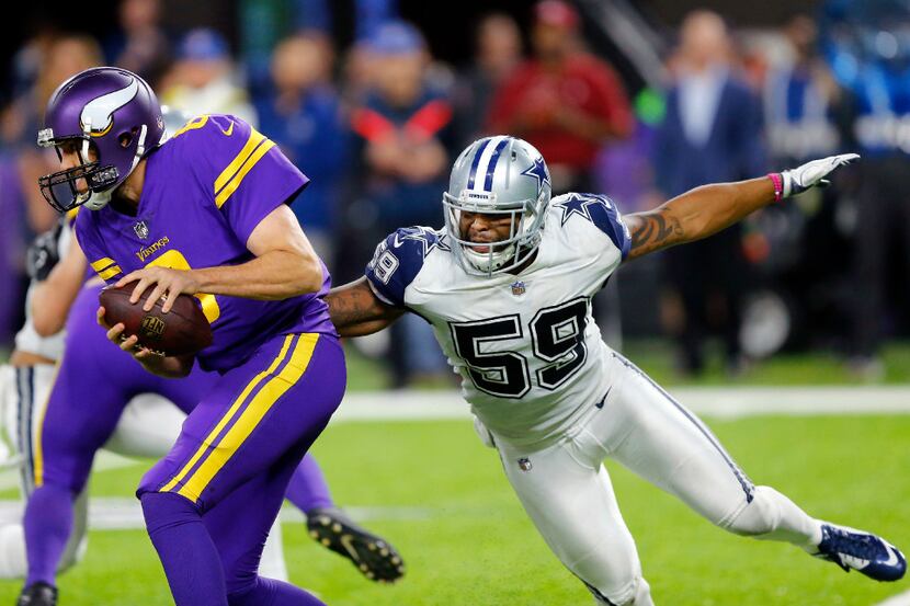 FILE - Cowboys linebacker Anthony Hitchens (59) closes in on a sack of Vikings quarterback...