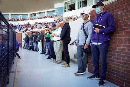 MLB scouts line the concourse to watch an NCAA baseball game between Mississippi and...