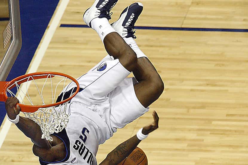  4/22/2007 -- Dallas' Josh Howard hangs on the rim after a dunkÂ in the second quarter, as...