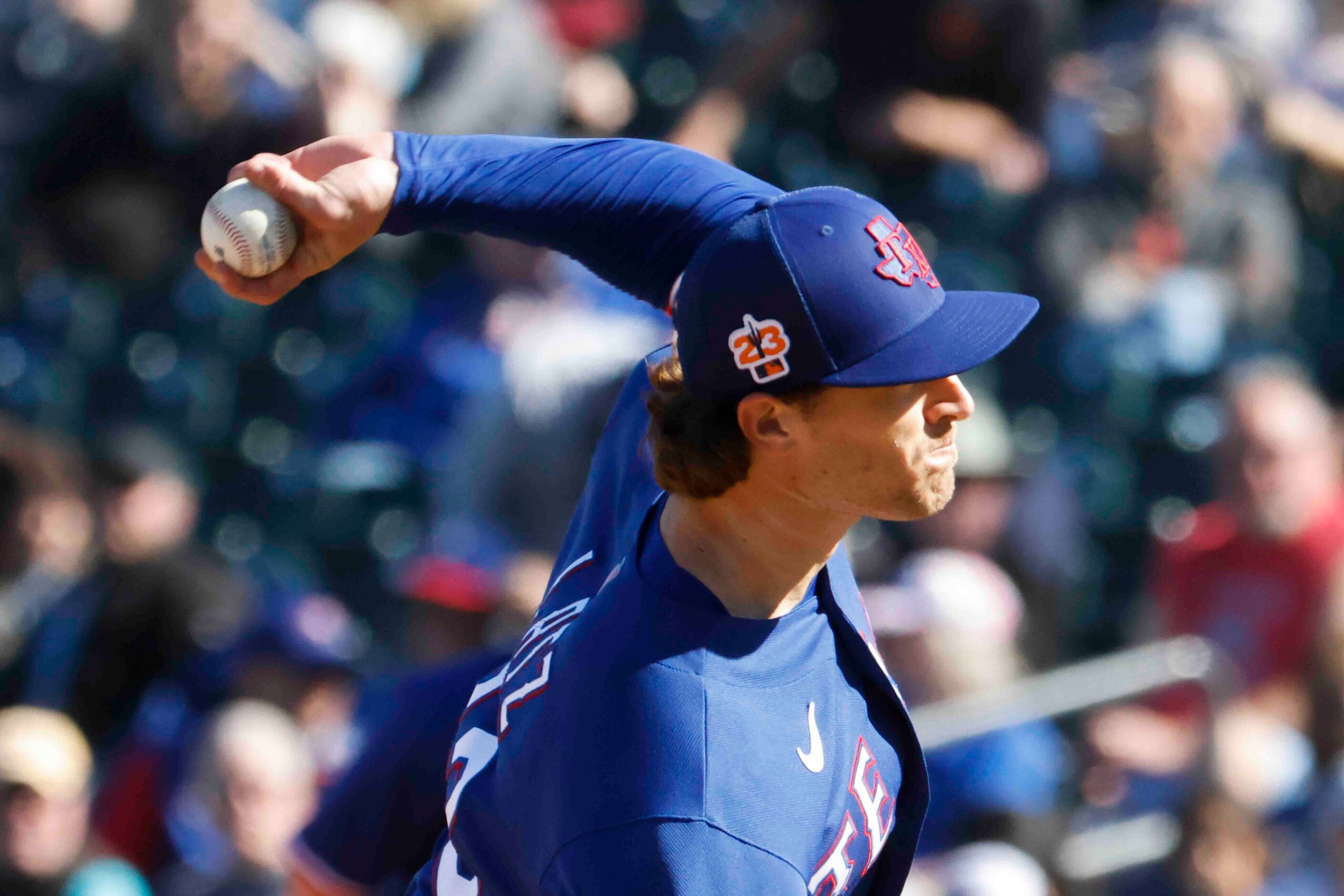 Texas Rangers Jake Latz throws during the sixth inning of a spring training game against the...