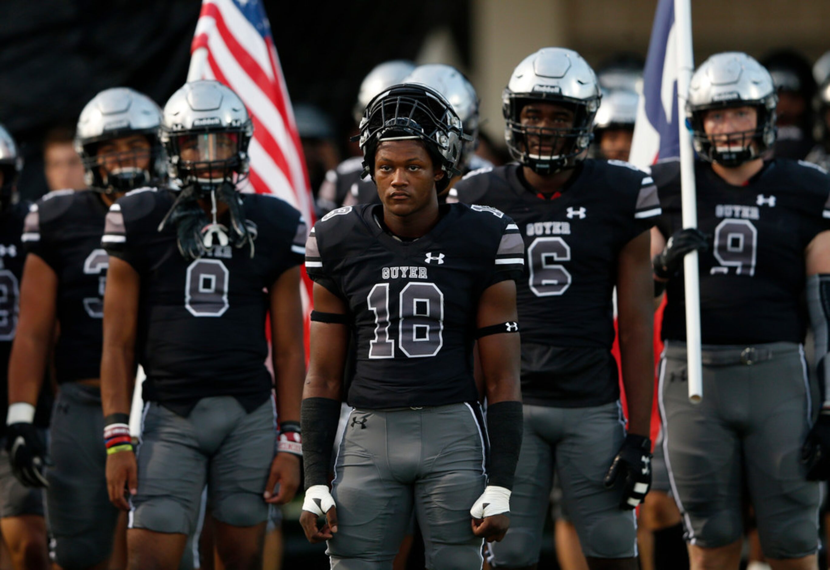 Denton Guyer's Jonathan Jones (18) and teammates prepare to take the field to play Southlake...