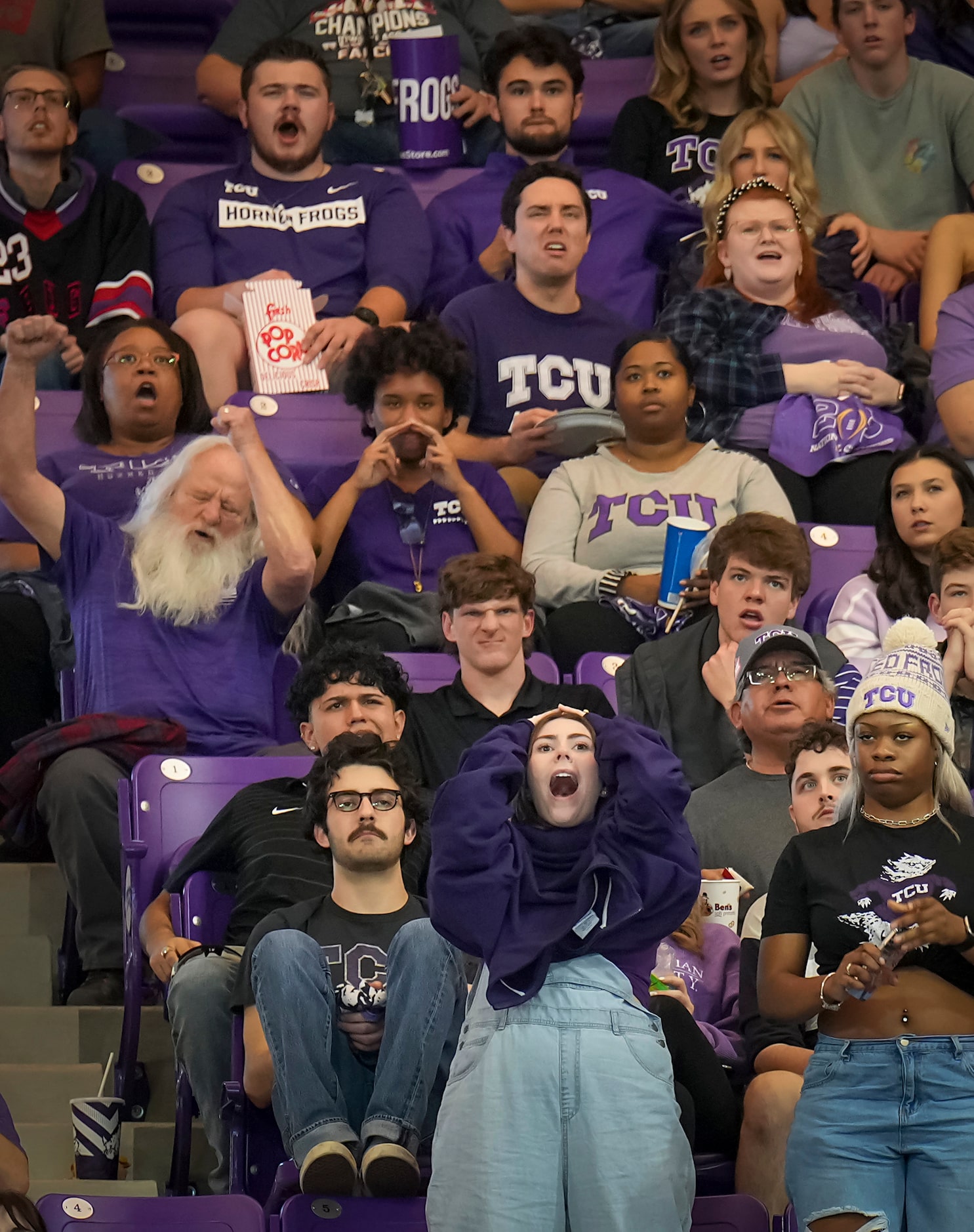 TCU fans react after a first half Horned Frogs interception during a College Football...