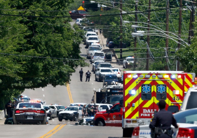 Dallas Police Officers work on the active shooting scene on Dolphin Road in Dallas on...