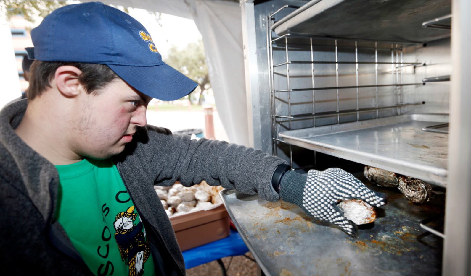 Scots Café student Ben Acker transferred baked potatoes into a hotbox to await sale during...