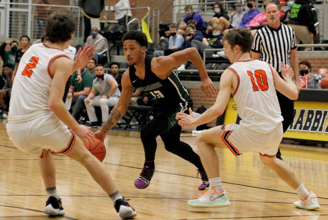 Waxahachie guard Preston Hodge (13) drives the ball as he is defended by Rockwall guards...