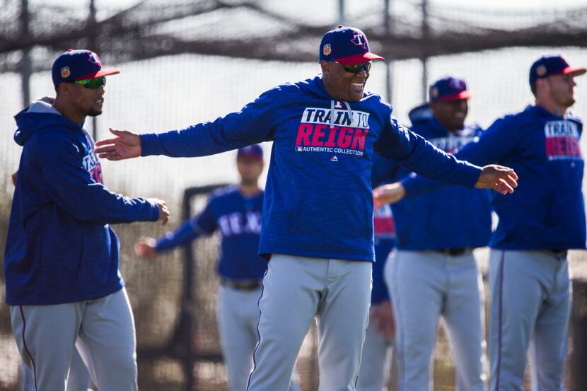 Texas Rangers third baseman Adrian Beltre (29) smiles as he stretches during a spring...