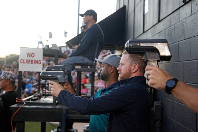 Professional scouts aim their radar guns as Colleyville Heritage pitcher Alex Scherff...