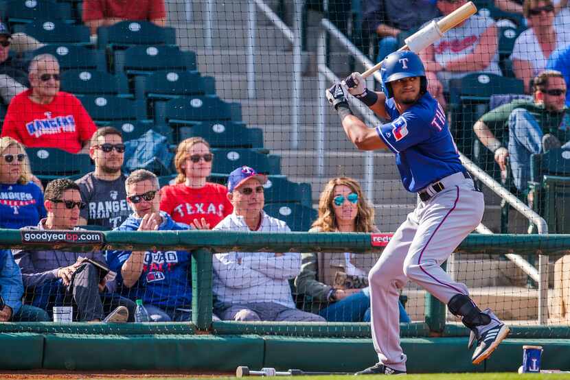 Texas Rangers general manager Jon Daniels (left) watches as Texas Rangers outfielder Bubba...