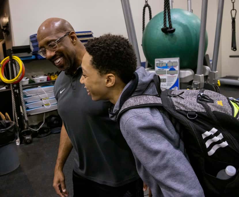 Michael Sorrell jokes with his son, Mike, after the younger Sorrell's strength training...