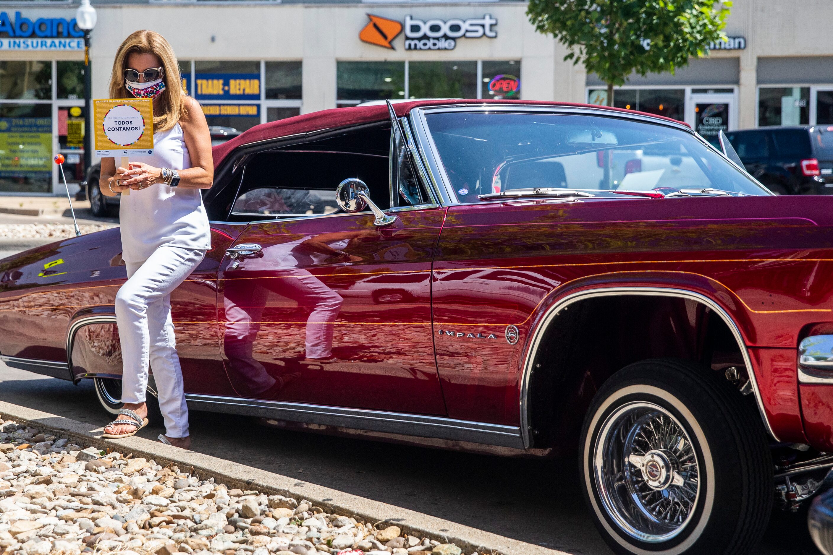 Dallas County Commissioner for District 4 Elba Garcia stands by a lowrider vehicle at one of...