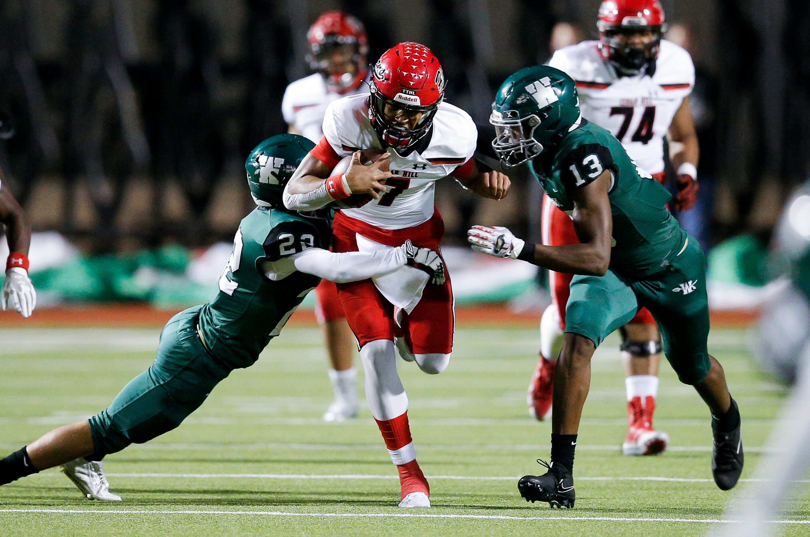 Waxahachie senior safety Jace Robinson (22) and senior defensive end JH’Marques Head (13)...