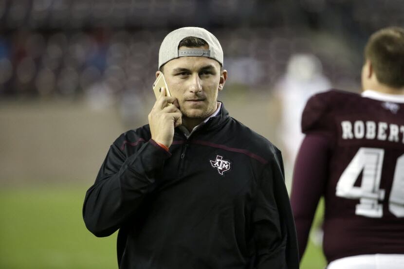 Cleveland Browns quarterback Johnny Manziel watches warmups before an NCAA college football...