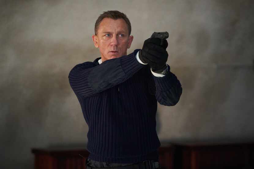 James Bond (Daniel Craig) prepares to shoot in 'No Time To Die.'