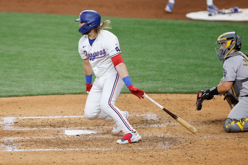 Texas Rangers third base Davis Wendzel (38) throws a bat after hitting a ball as Oakland...