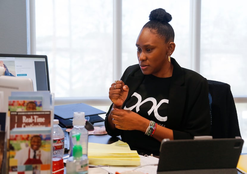 Bianca Walker, a deaf and hard of hearing access specialist, signs during a video call at...