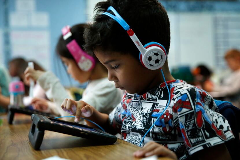 First grader Aiden Diaz works on an iPad at Frisco ISD's Bright Academy in Frisco Thursday....