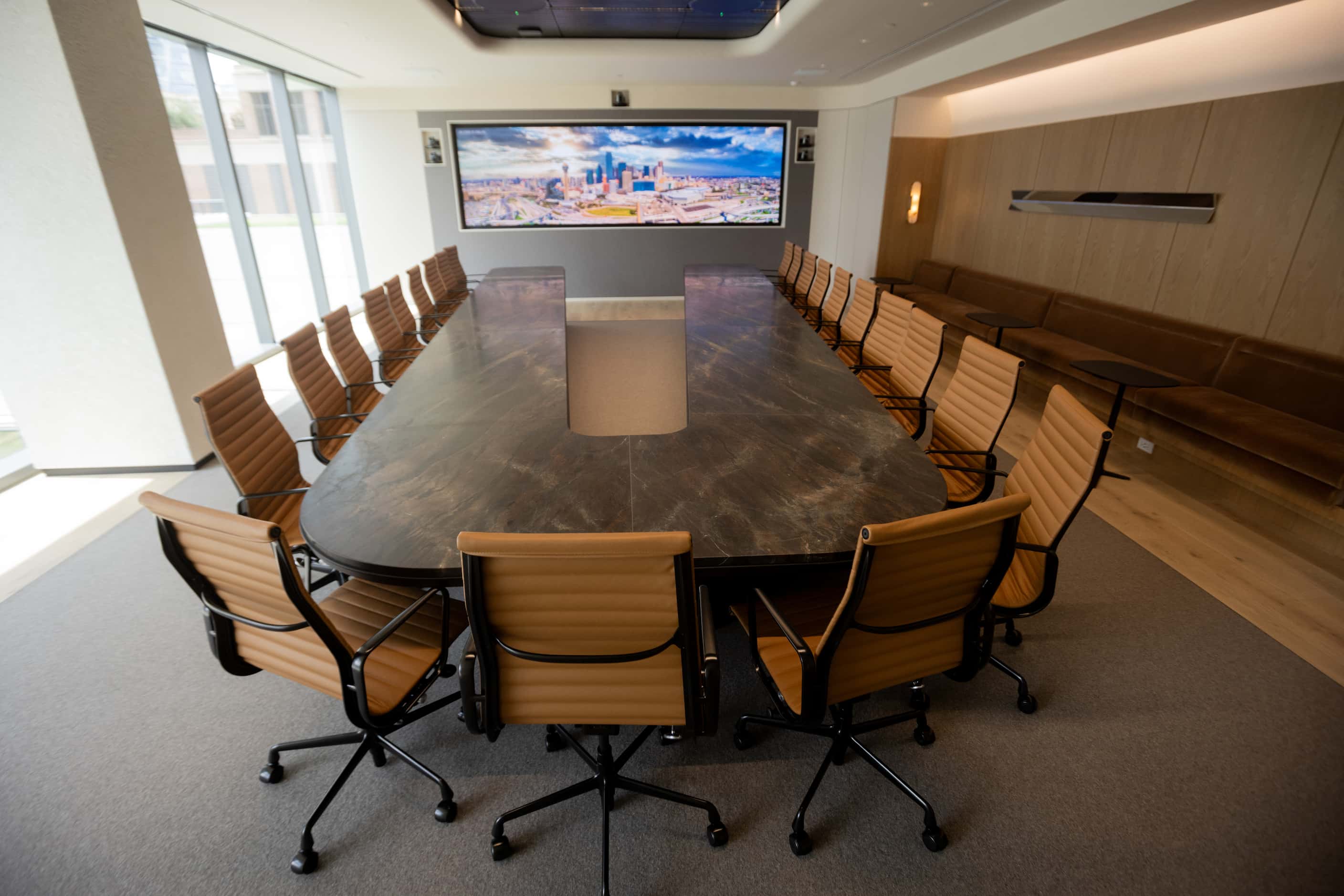 CBRE's boardroom features a horseshoe-shaped table finished with honed marble. Technology is...