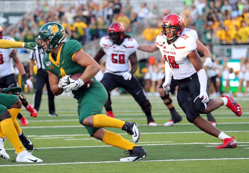 WACO, TEXAS - OCTOBER 12: Clay Johnston #4 of the Baylor Bears is chased by Cameron Cantrell...