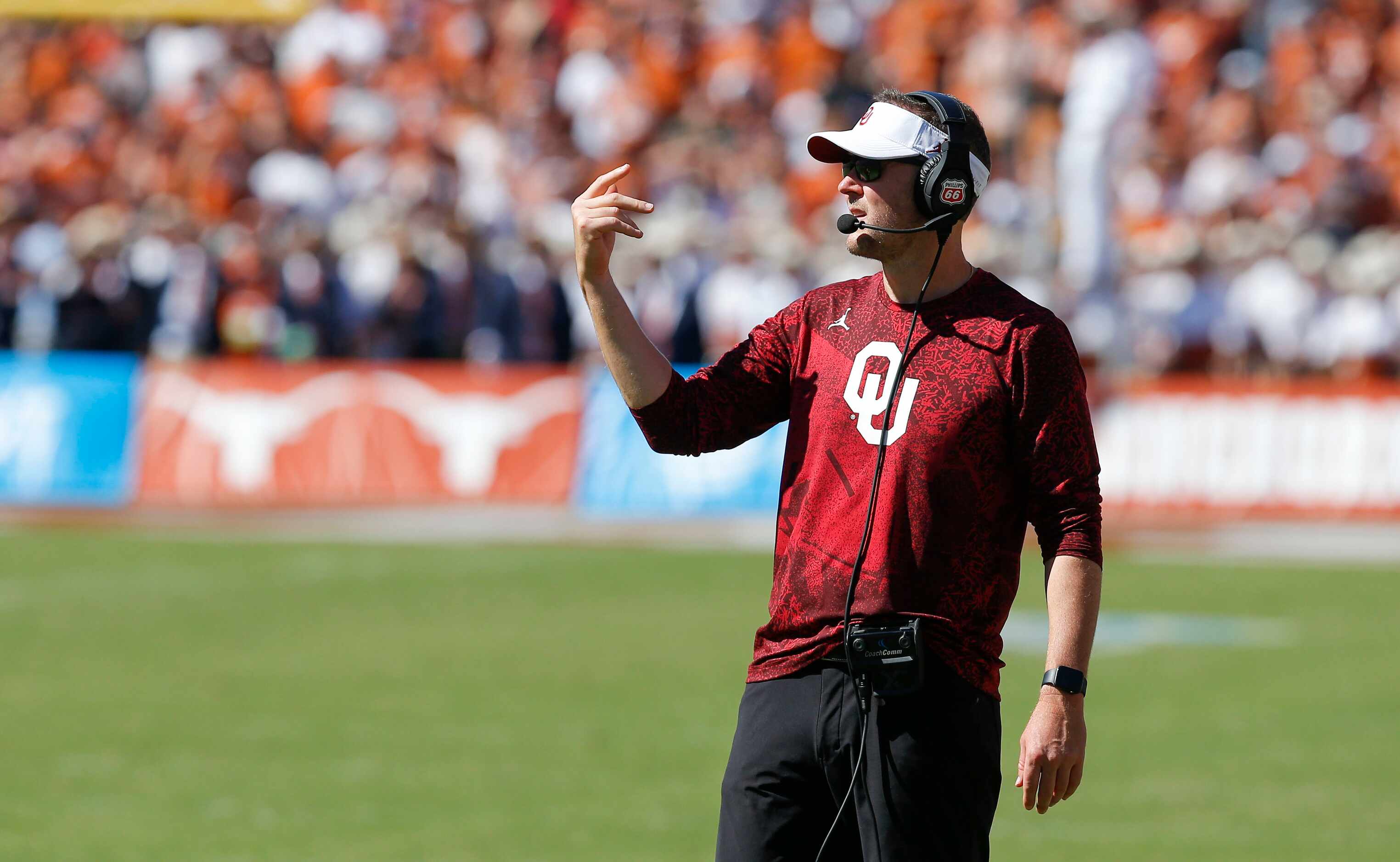 Oklahoma head coach Lincoln Riley signals to his team during the second half of an NCAA...