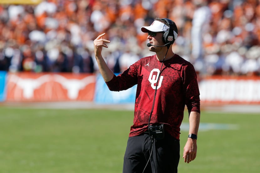 Oklahoma head coach Lincoln Riley signals to his team during the second half of an NCAA...