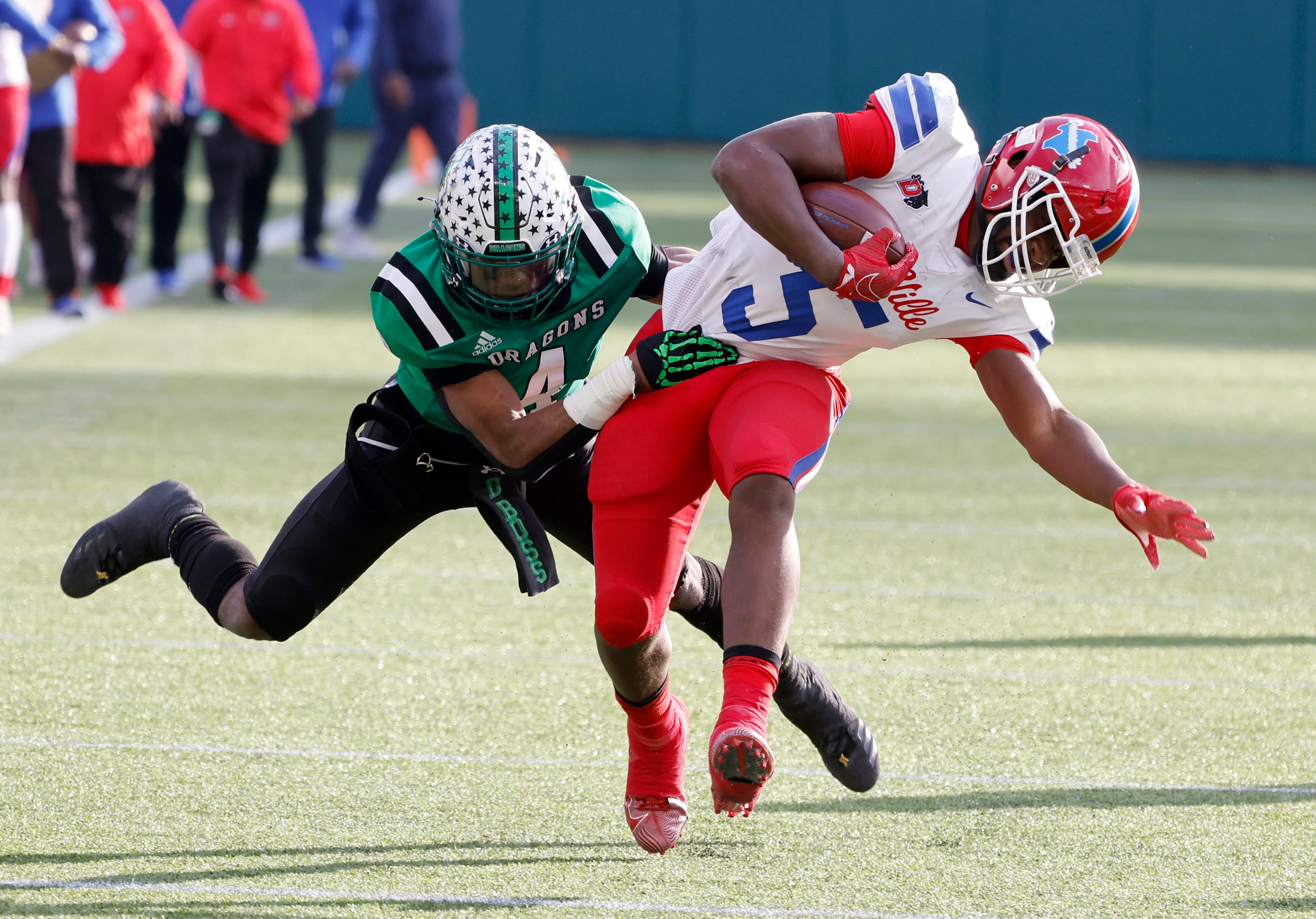 Southlake Carroll’s Cinque Williams (4) tackles Duncanville’s Malachi Medlock (5) during the...