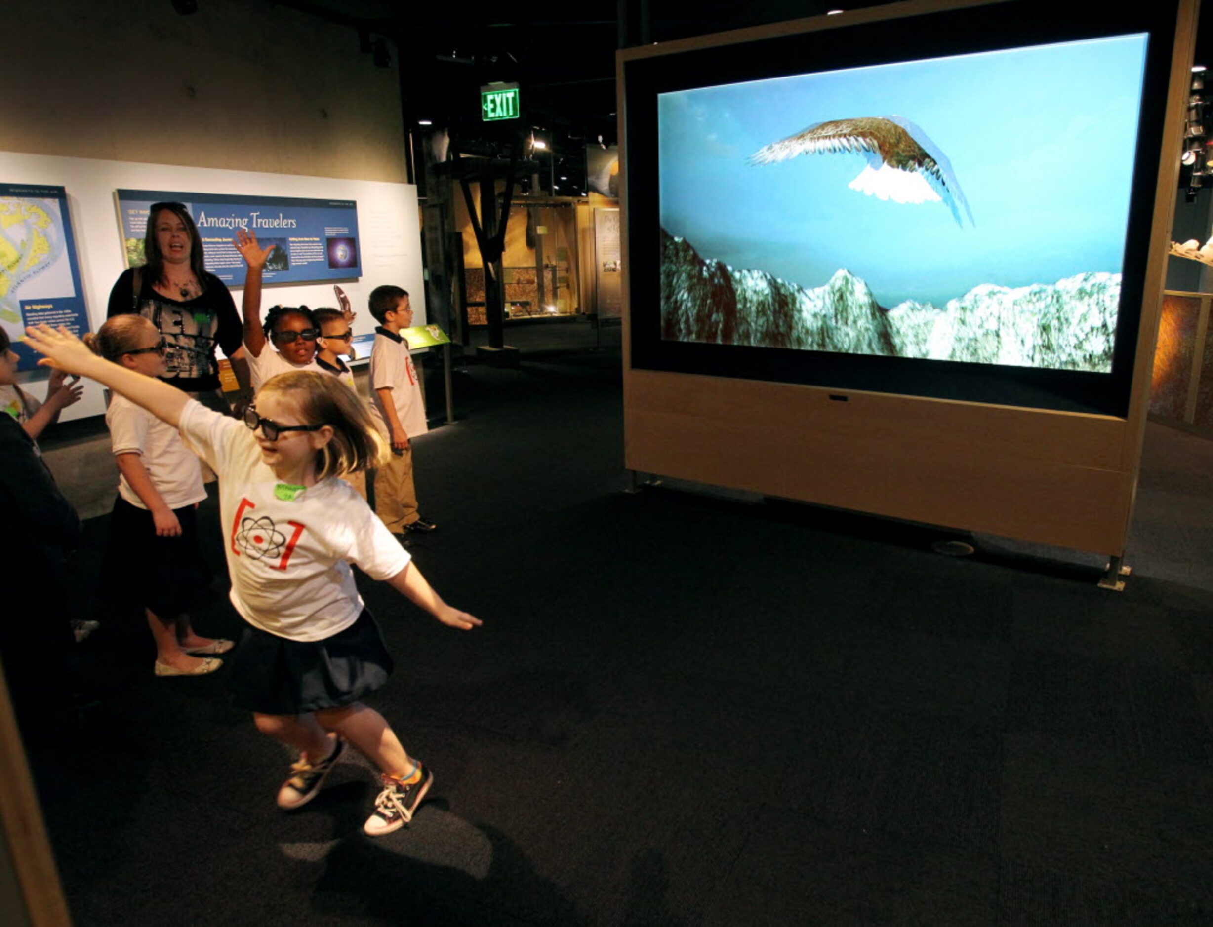 Meagan Hanks, left, flies an interactive bird that mimics her movement in the Rose Hall of...