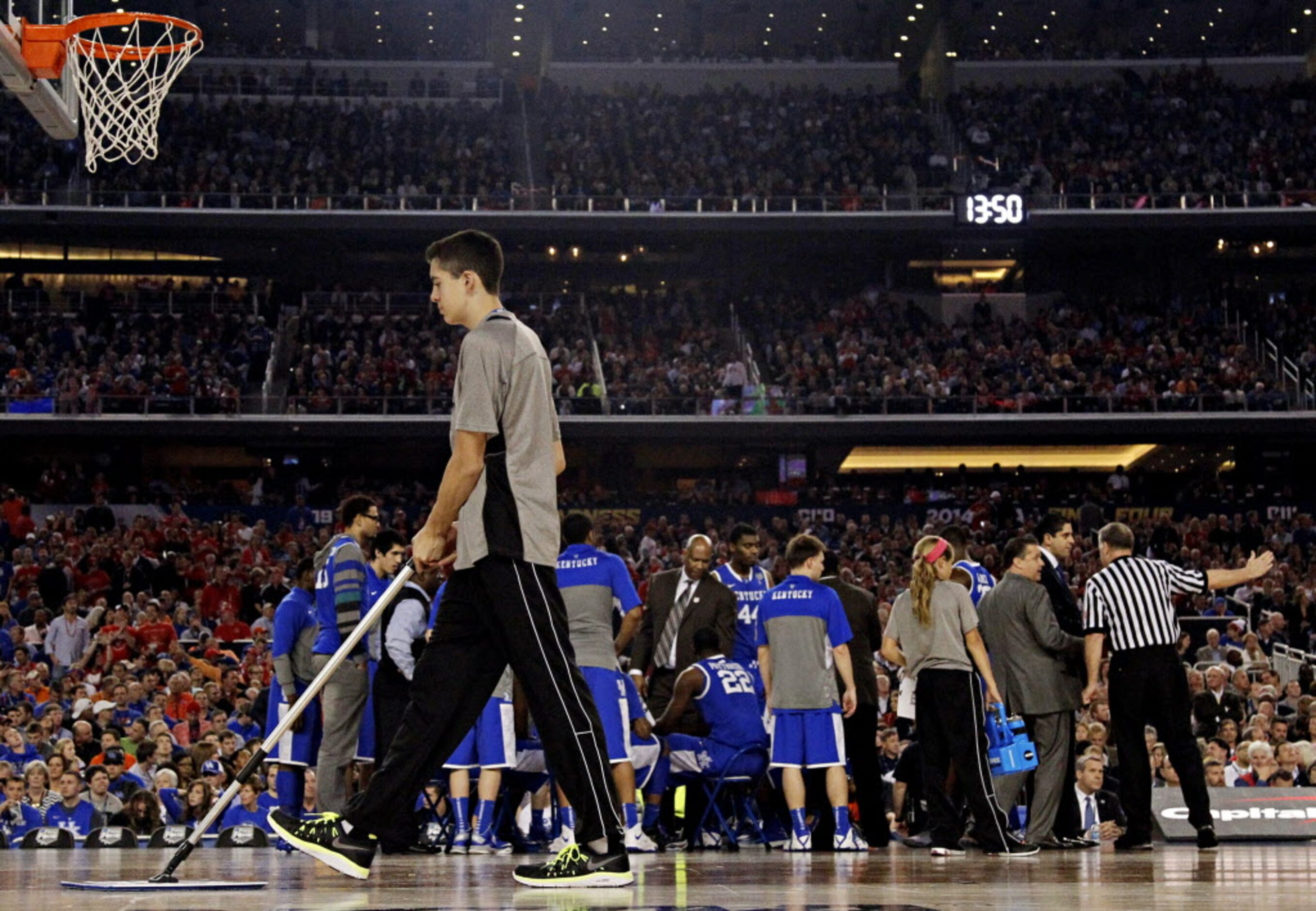 A ball kid wipes sweat during the first half of the Wisconsin Badgers NCAA Final Four game...