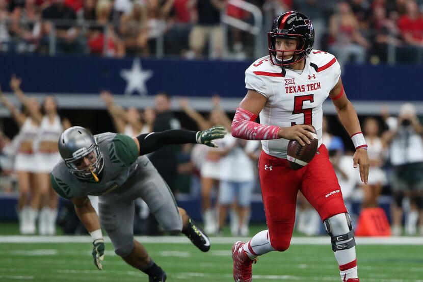 Texas Tech Red Raiders quarterback Patrick Mahomes (5) runs with the ball in the first half...