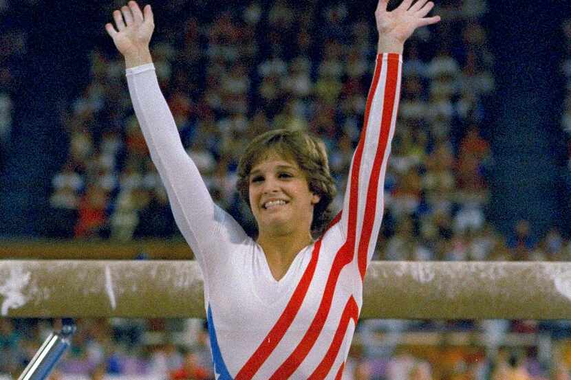 FILE- Mary Lou Retton reacts to applause after her performance at the Summer Olympics in Los...