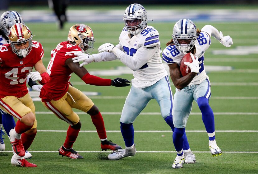 Dallas Cowboys wide receiver CeeDee Lamb (88) picks up an onside kick and races for a fourth...