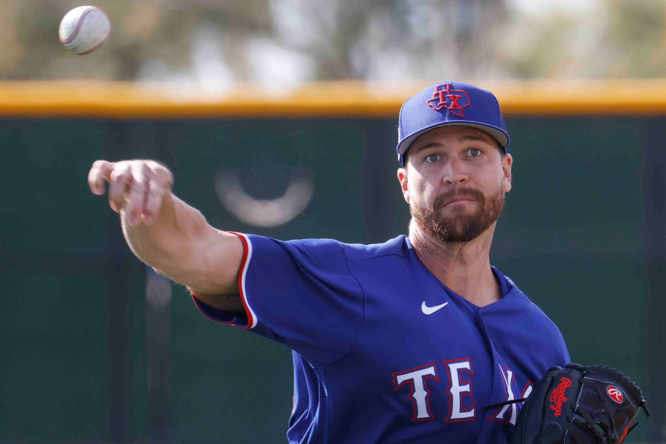 Texas Rangers pitcher Jacob deGrom throws a pitch during a spring training workout at the...