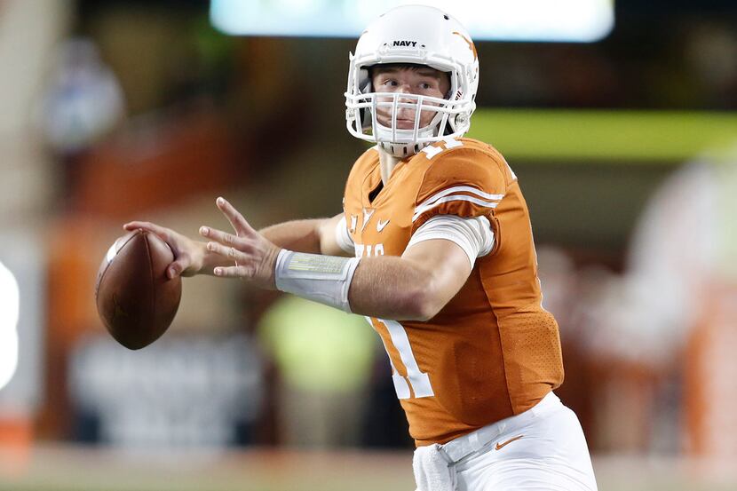 Texas quarterback Sam Ehlinger looks for receiver against Kansas during the first half of an...