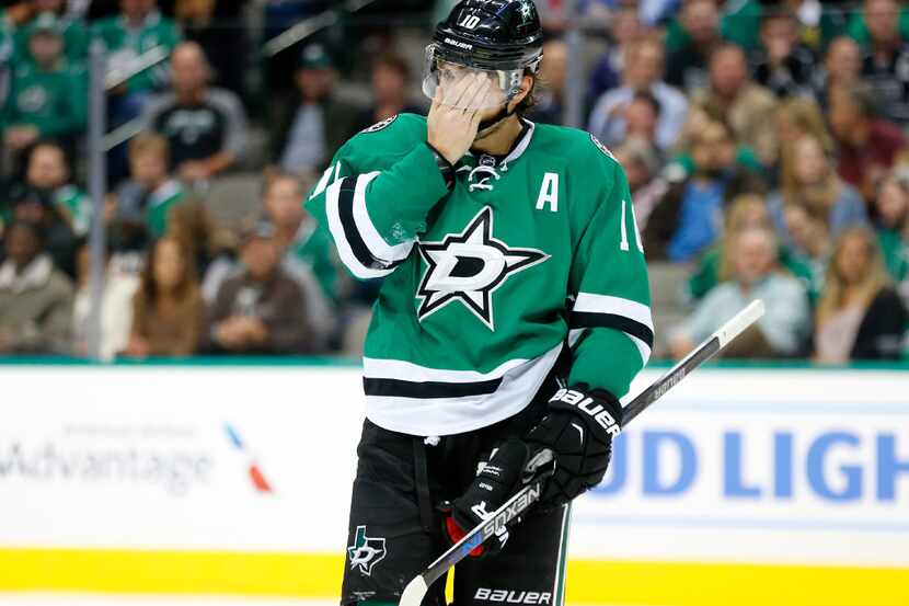 Dallas Stars left wing Patrick Sharp (10) skates to the bench after hitting his head on a...