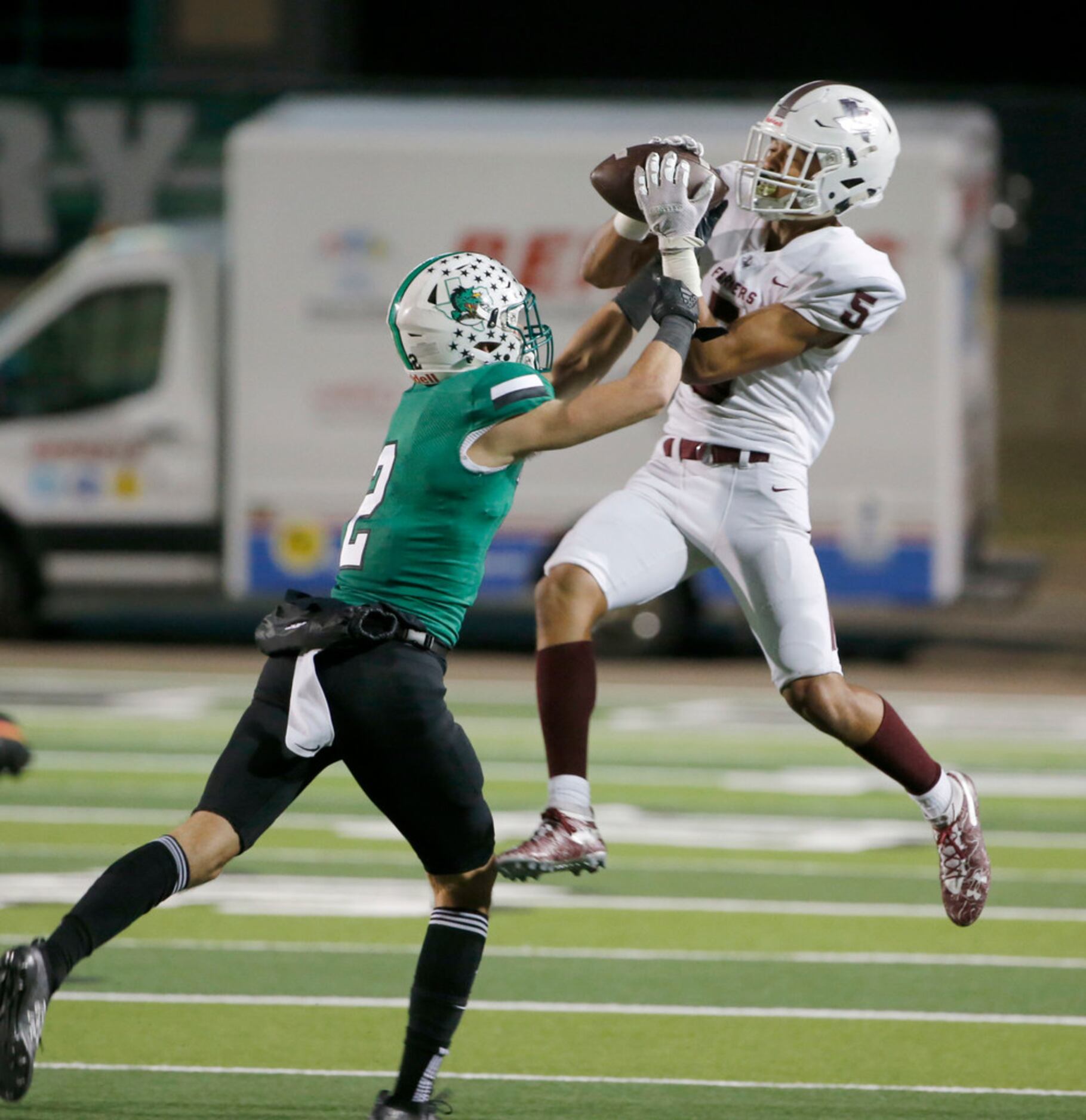 Lewisville reciever Isiah Stevens (5) makes a catch in front of Southlake's Dylan Thomas (2)...