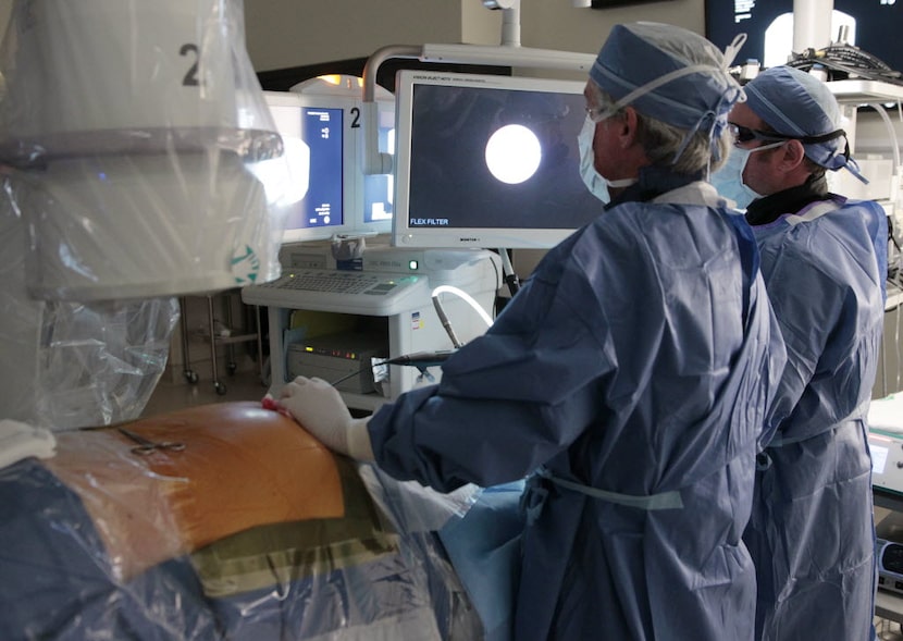 A doctor performs surgery at Forest Park Medical Center in 2014. (David Woo/The Dallas...