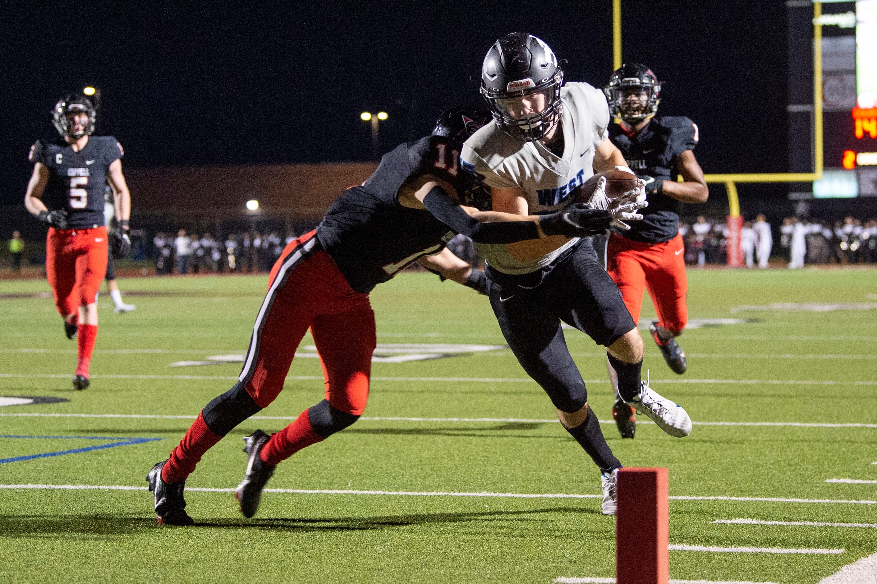 Plano West senior wide receiver Jackson Stambaugh (15) is kept out of the end zone by...