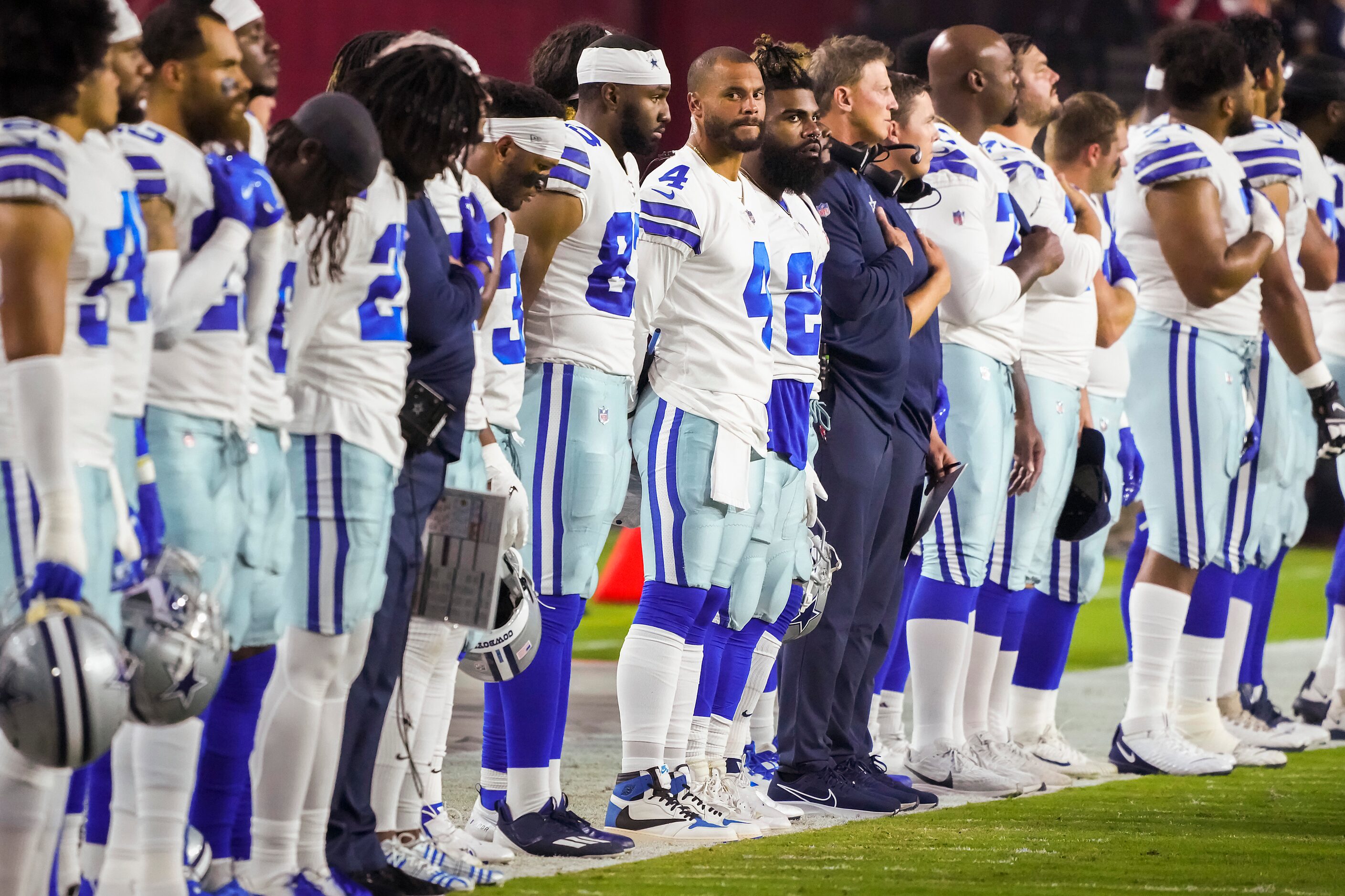 Dallas Cowboys quarterback Dak Prescott (4) and running back Ezekiel Elliott (21) stand for...