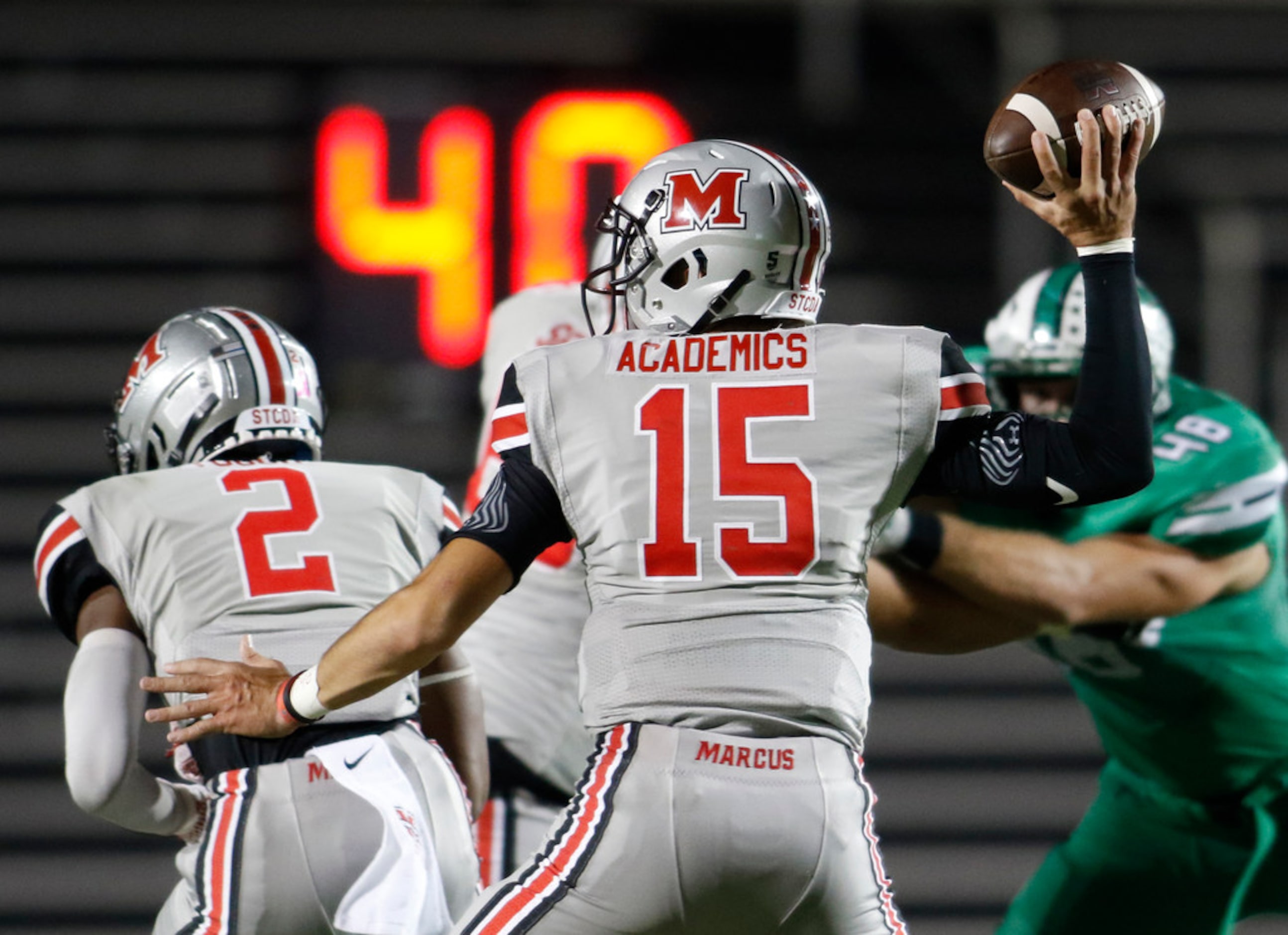 Flower Mound Marcus quarterback Xavier Maxwell (15) launches a pass during first half action...