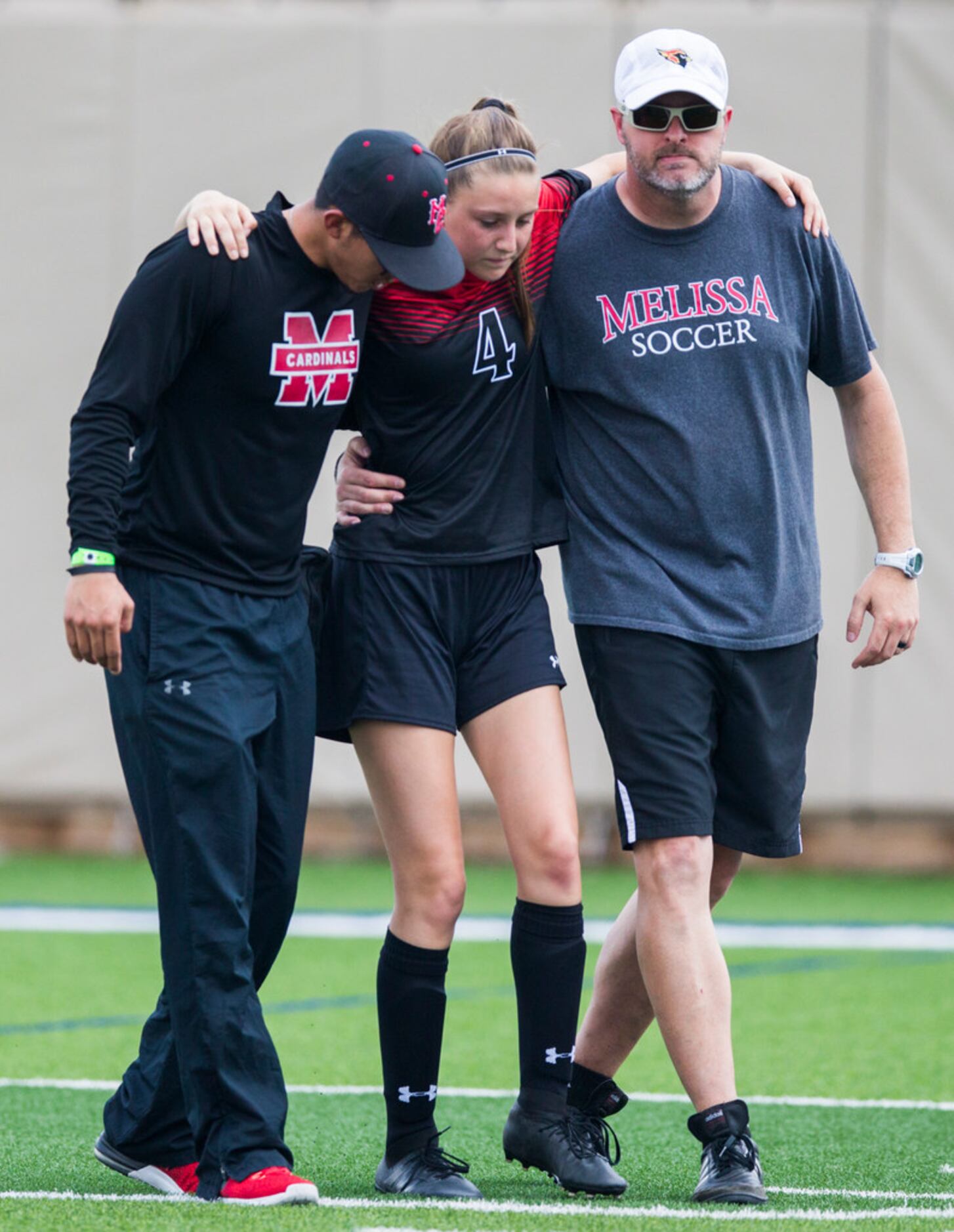 Melissa midfielder Bobbi Brosamle-Norton (4) is helped off the field after an injury during...