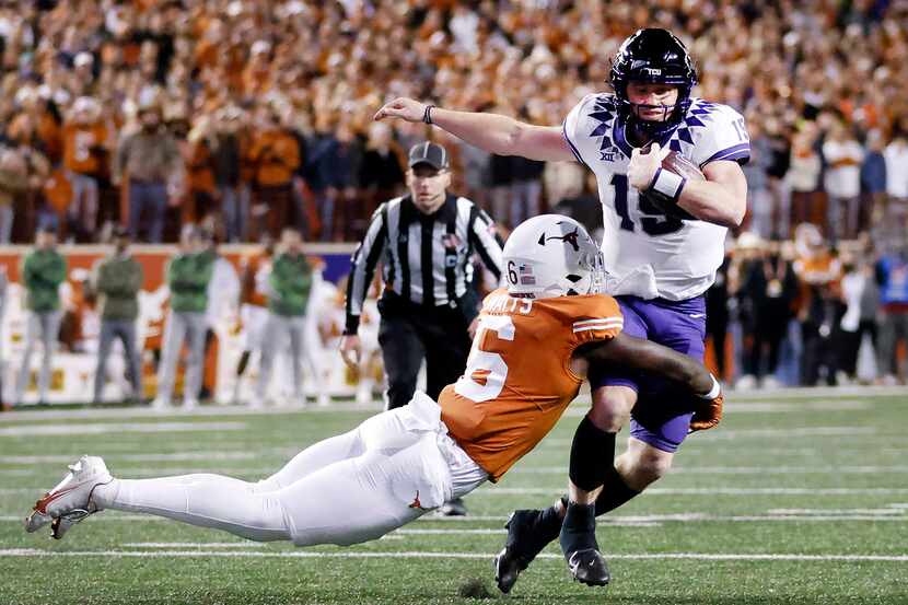 TCU Horned Frogs quarterback Max Duggan (15) is tackled in the open field by Texas Longhorns...