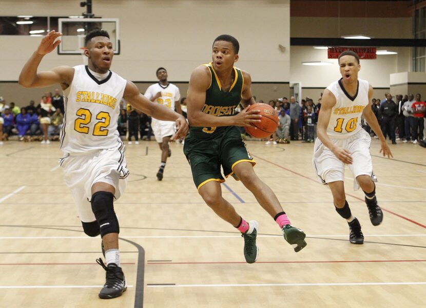 Madison guard Admon Gilder (3) drives on Triple A Academy guard King McClure (22)  and guard...