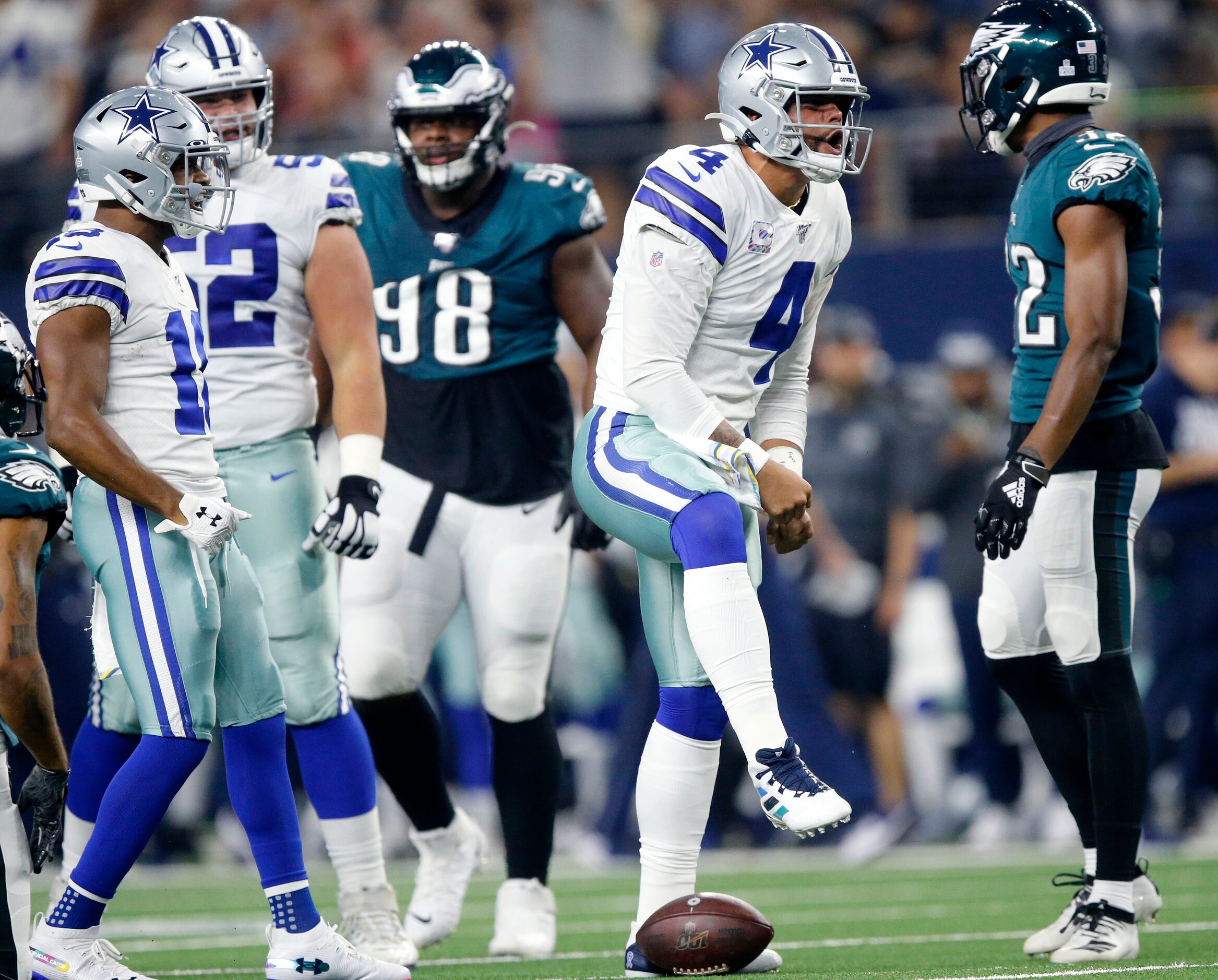 Dallas Cowboys quarterback Dak Prescott (4) celebrates his first quarter run against the...