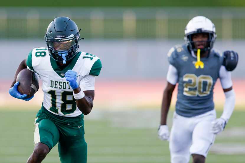 DeSoto wide receiver Ethan Feaster (18) runs for a touchdown after a catch during the first...