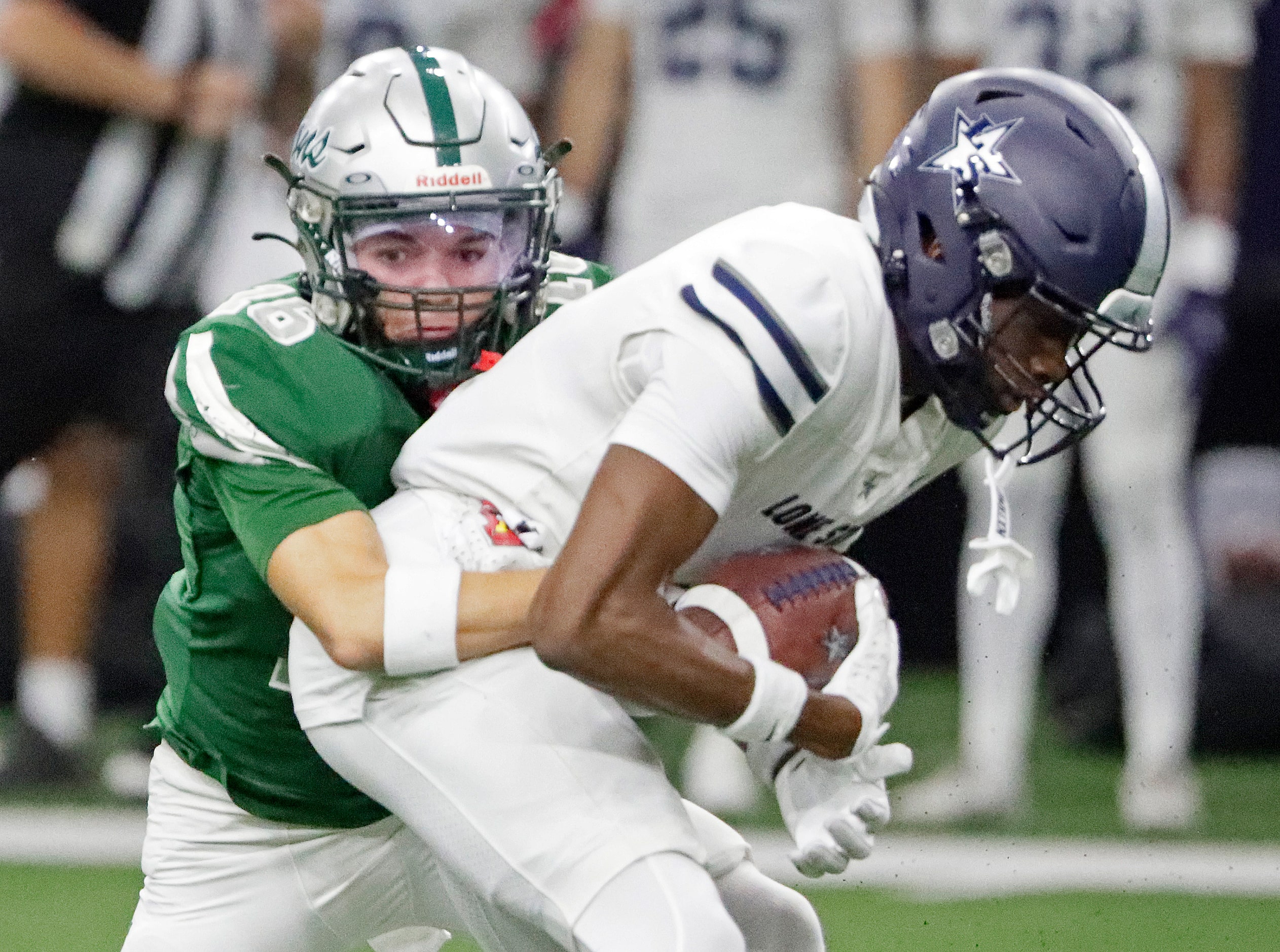 Lone Star High School wide receiver Bryson Jones (4) is tackled after the catch by Reedy...