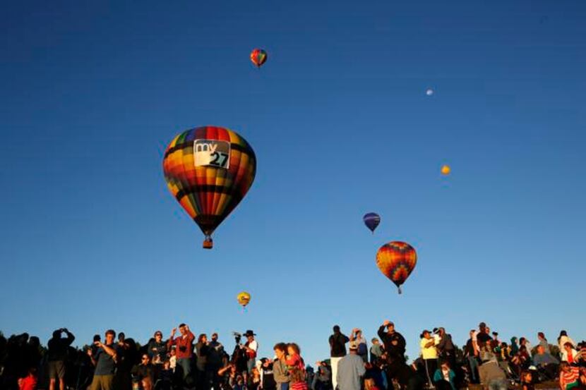 Hot air balloons take off during a balloon festival at Oak Point Park in Plano last year....