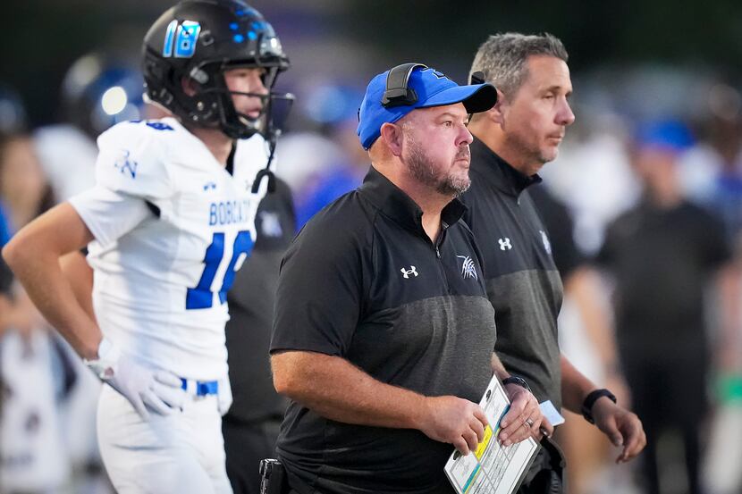 Trophy Club Byron Nelson head coach Travis Pride works on the sidelines during the first...