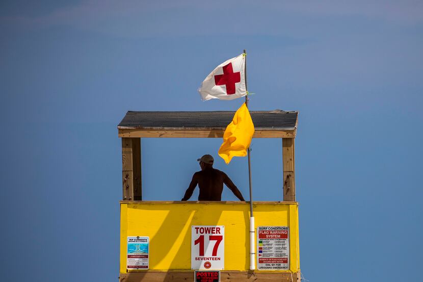 A Port Aransas Beach Guard looks out from a tower in Port Aransas, Texas. 